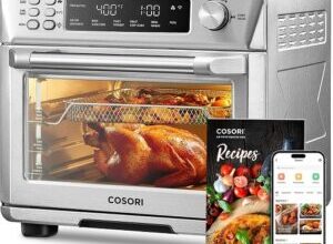 COSORI Smart 11-in-1 Air Fryer Toaster Oven Combo in stainless steel on a modern kitchen countertop.