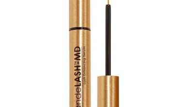 "Grande LASH-MD Lash Enhancing Serum bottle with long, thick eyelashes."